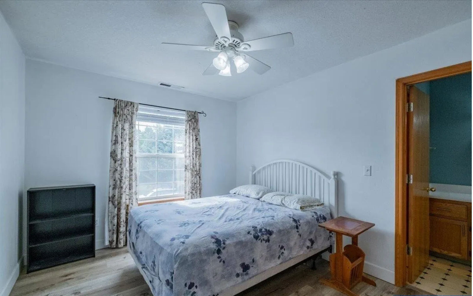 Primary bedroom before redesign, with dated furnishings